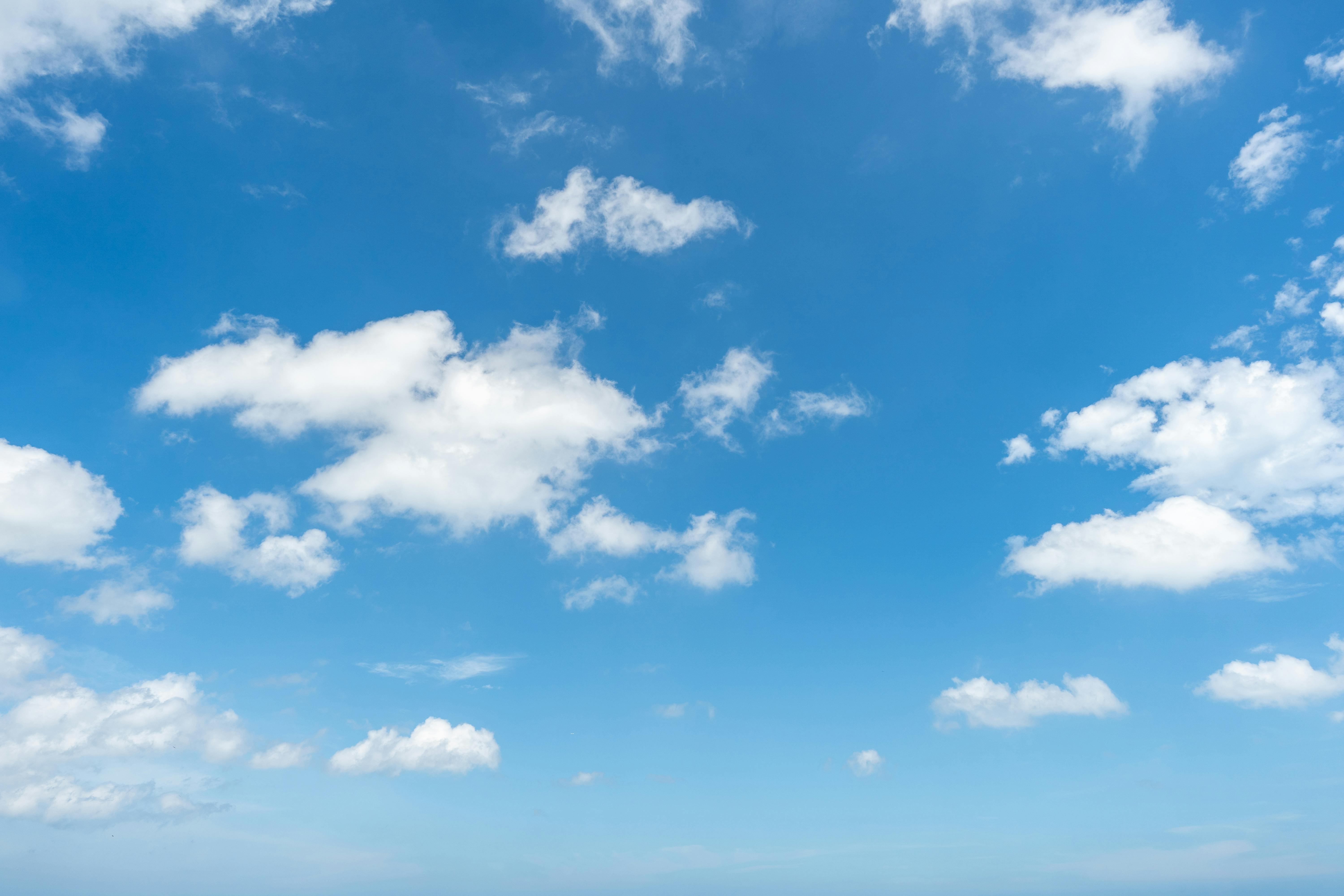 Open blue sky with soft clouds